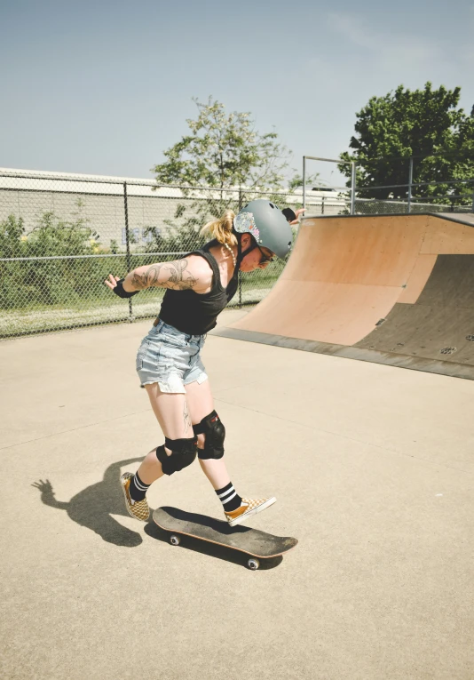 a female skateboarder is preparing to take off on the board