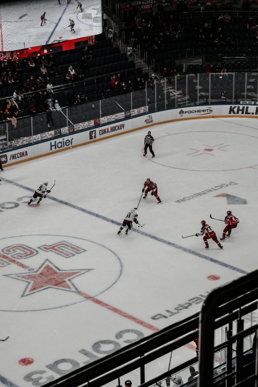 an ice hockey game as the goalies look on