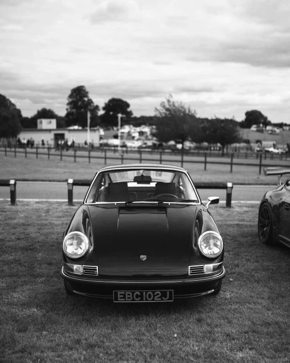 two black and white pographs of porsche sports cars