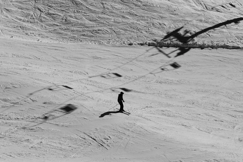 the shadows of a person are cast on the snow