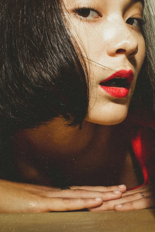 a women with long hair and wearing red lipstick