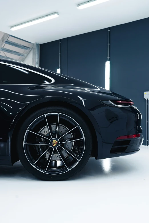 a black car parked inside of a garage