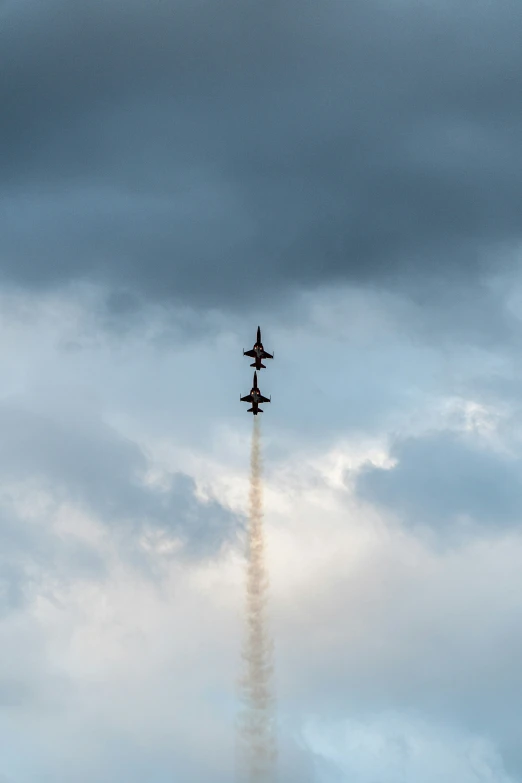 an airplane flies through the cloudy sky