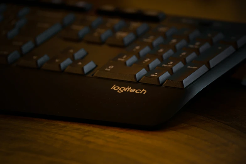 a computer keyboard is placed on the desk