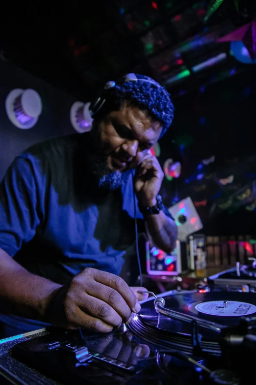 a dj mixes in front of a record player