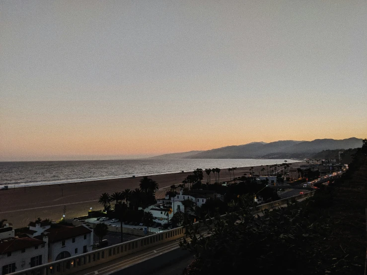 the beach is beside a highway near some houses