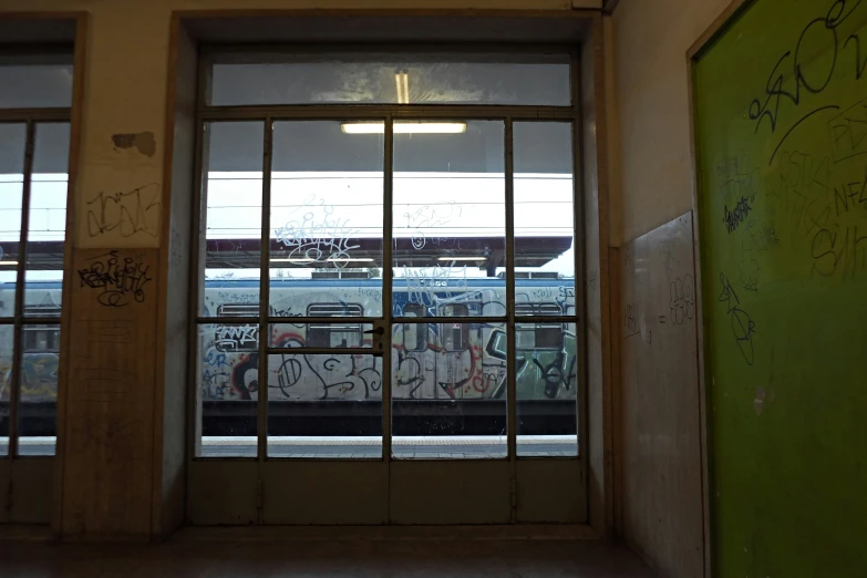 a window on the side of a building with graffiti on it