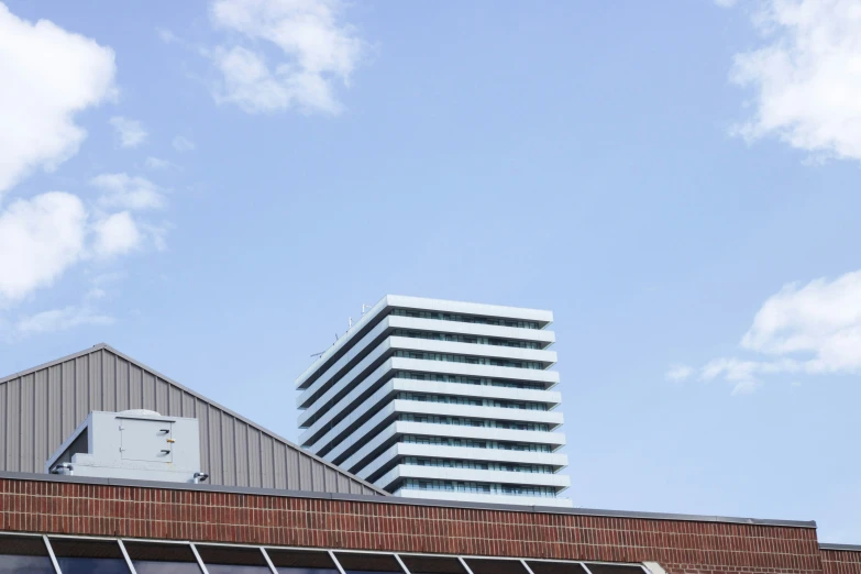 an office building against a partly cloudy sky