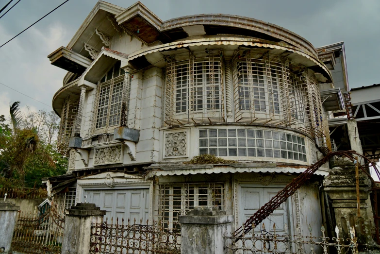 old run down house has arched windows and doors