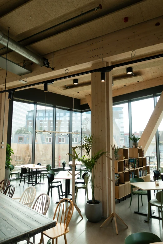 the empty dining area is very empty with tables, chairs, and shelves