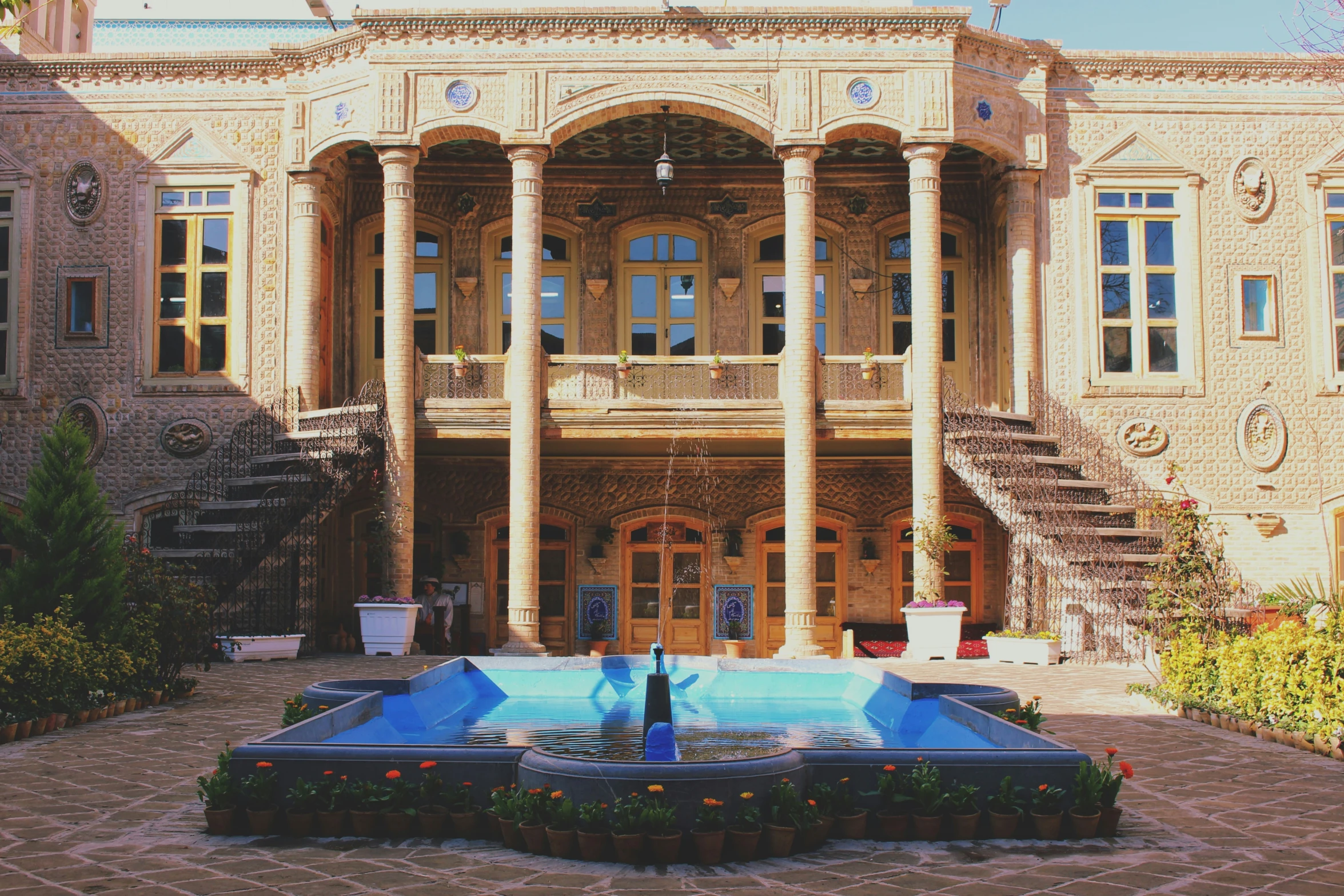 an ornate building with a fountain in front