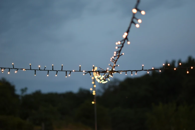 a lot of lights on top of a fence at night