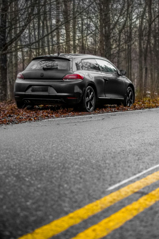 a black porsche suv parked on the side of the road