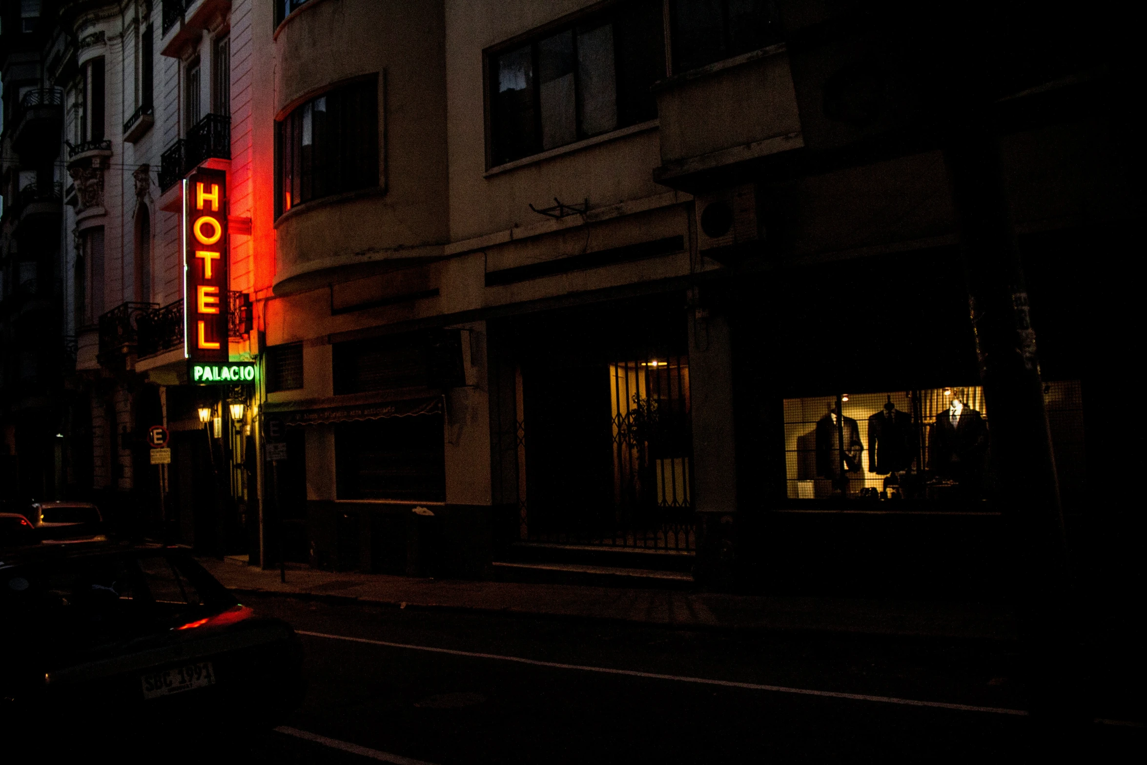 a motel sign is lit up in a dark night