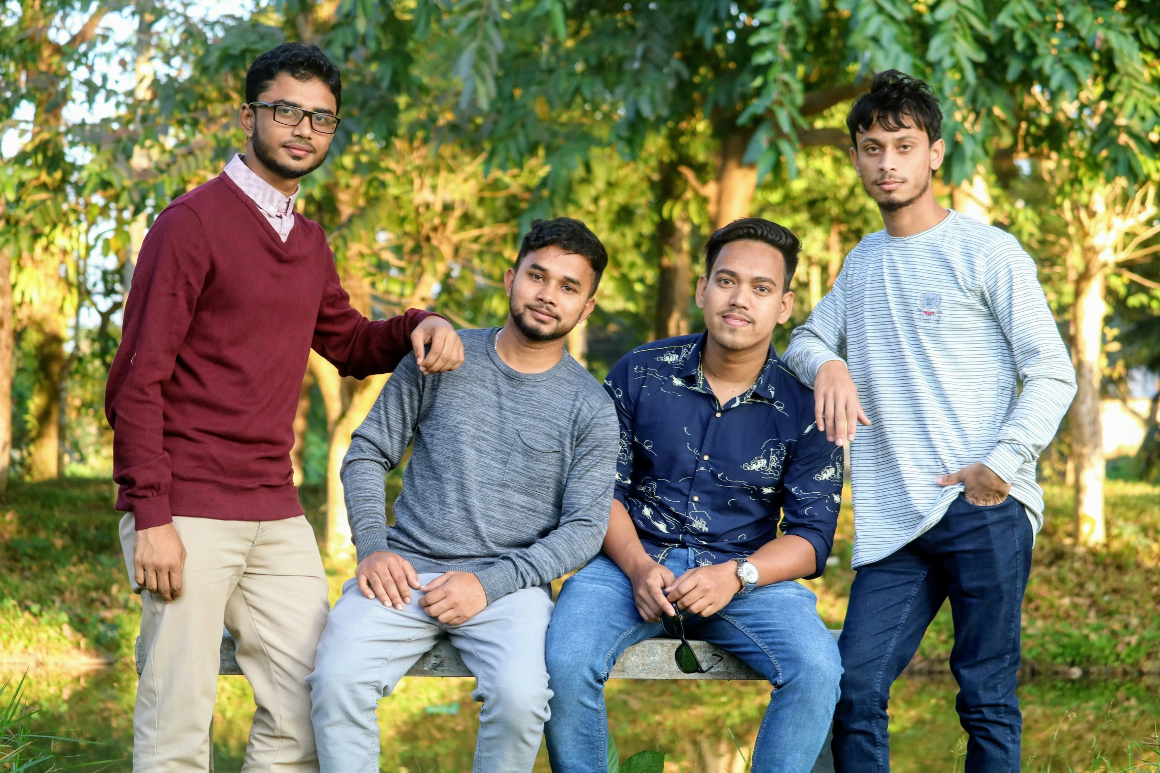 three men are posing for a po in a park