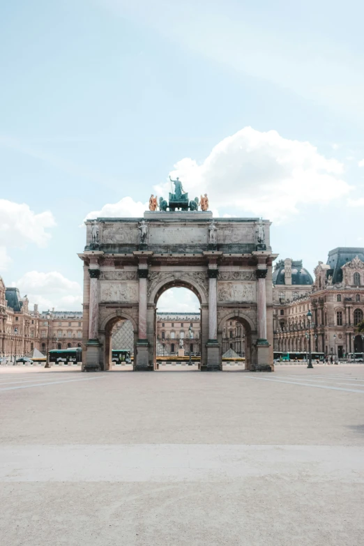 a building with an archway and two clock towers