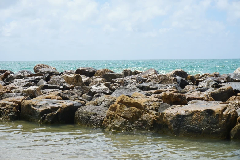 a large body of water next to rocky shore