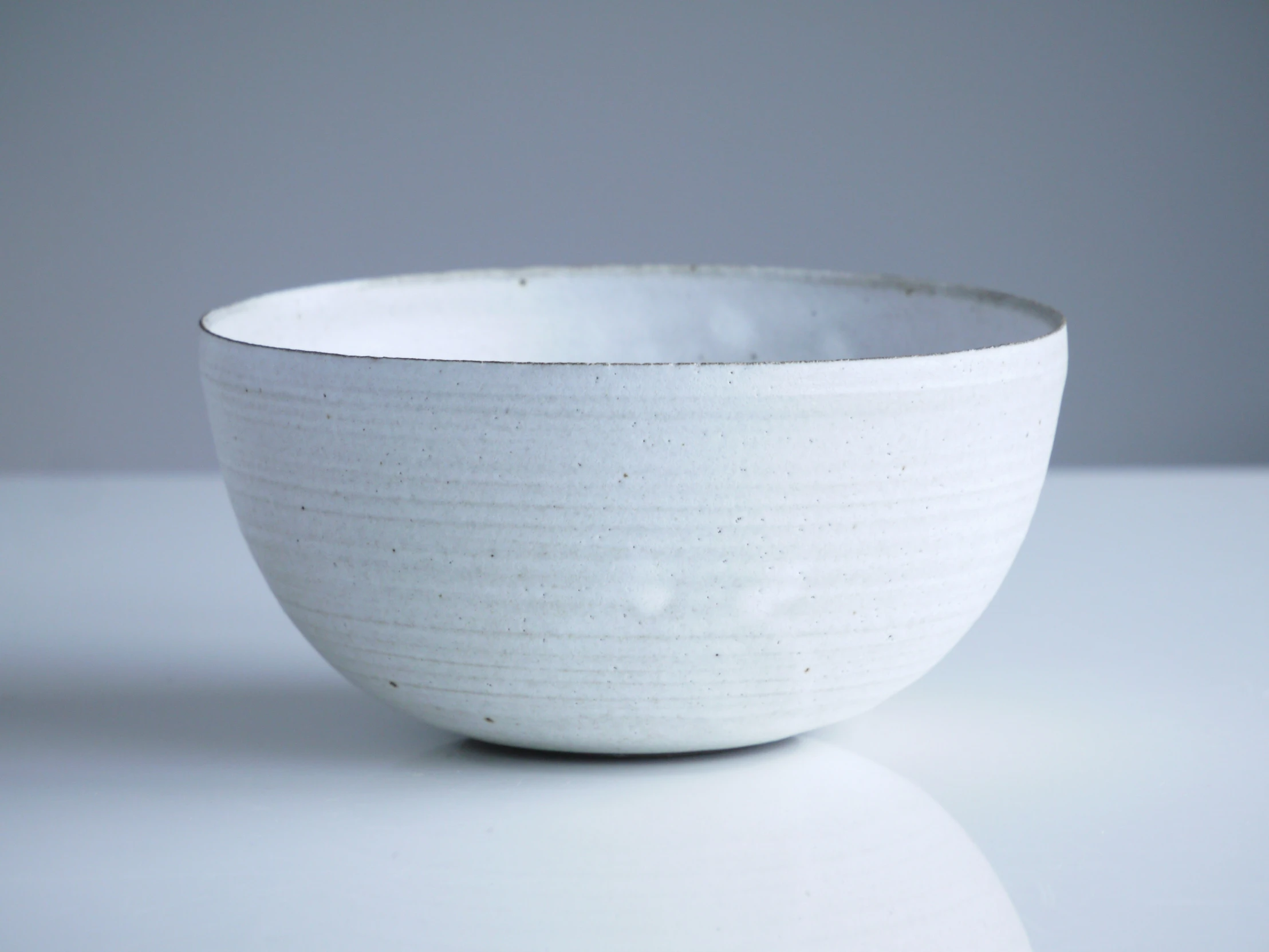 a bowl sitting on top of a white table