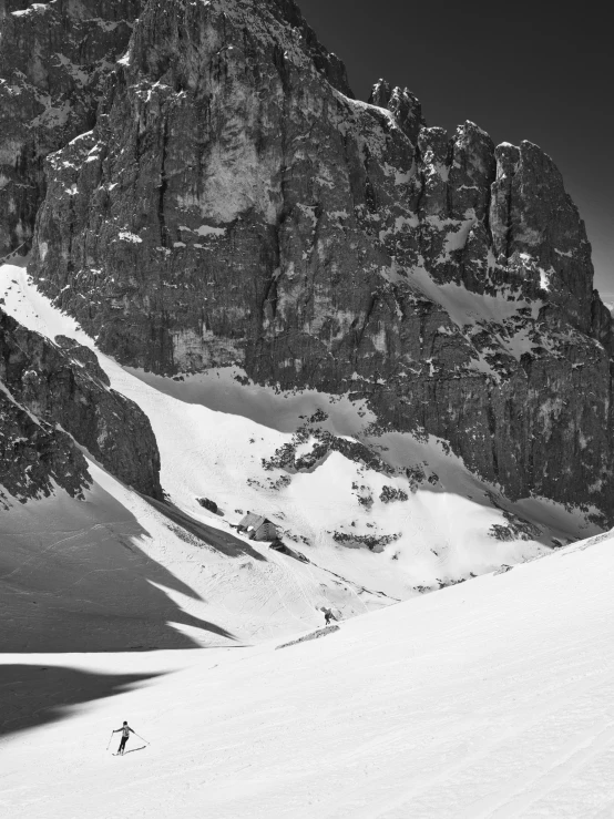 a skier skiing down a hill between two massive mountains