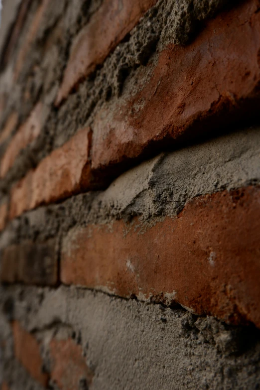 a closeup of a brick wall with the light shining on it