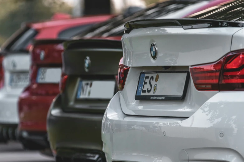 a row of parked bmw cars on the road