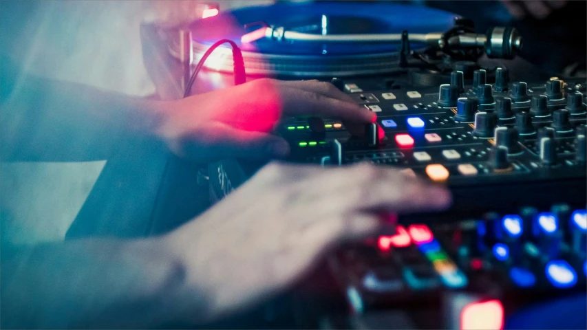 the two hands are touching a dj mixing a track