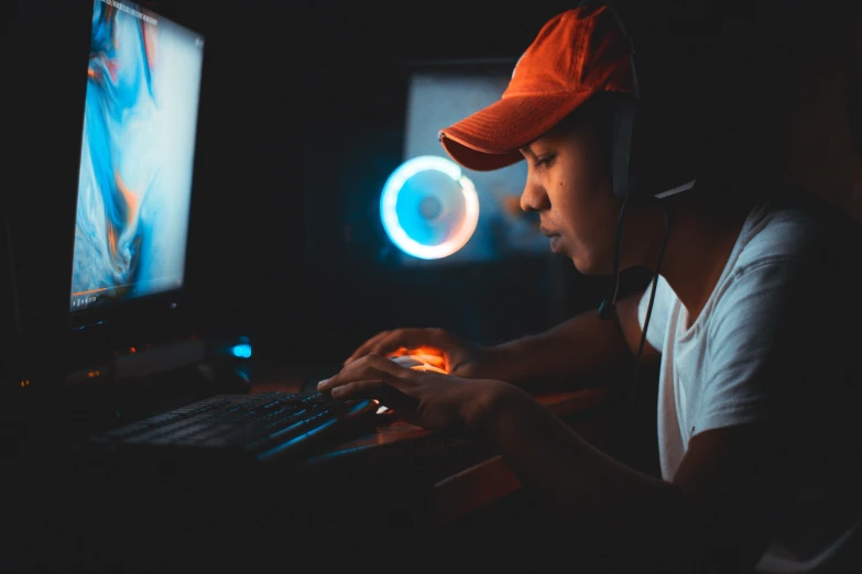 a person using a laptop computer in a dark room