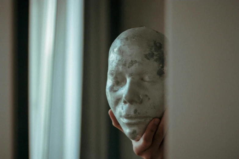 a person is using a clay face mask in a room