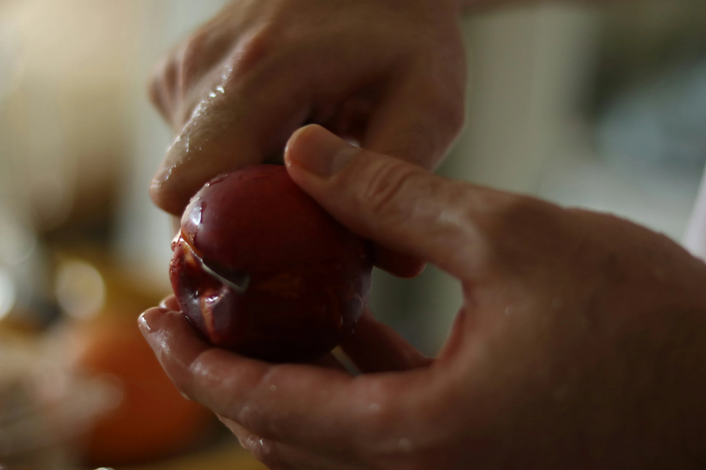 hands peeling an apple into it in the kitchen