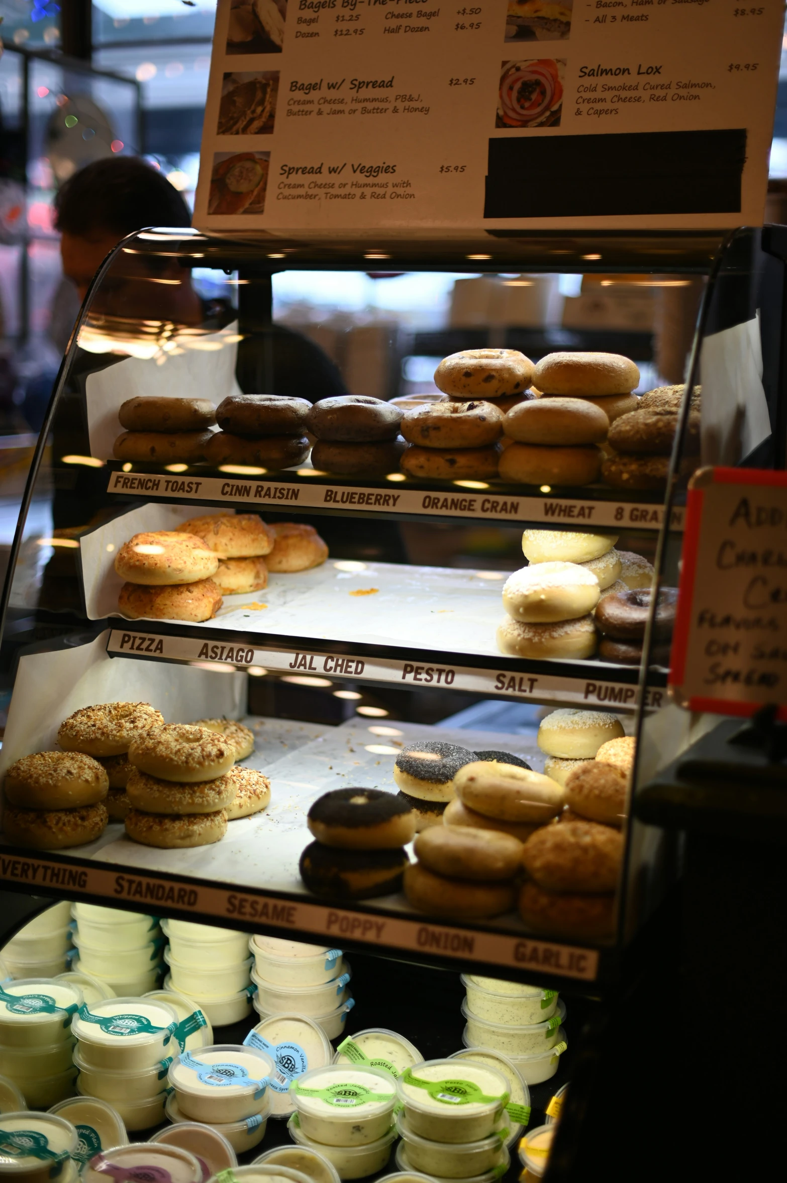 a display case filled with many different types of doughnuts