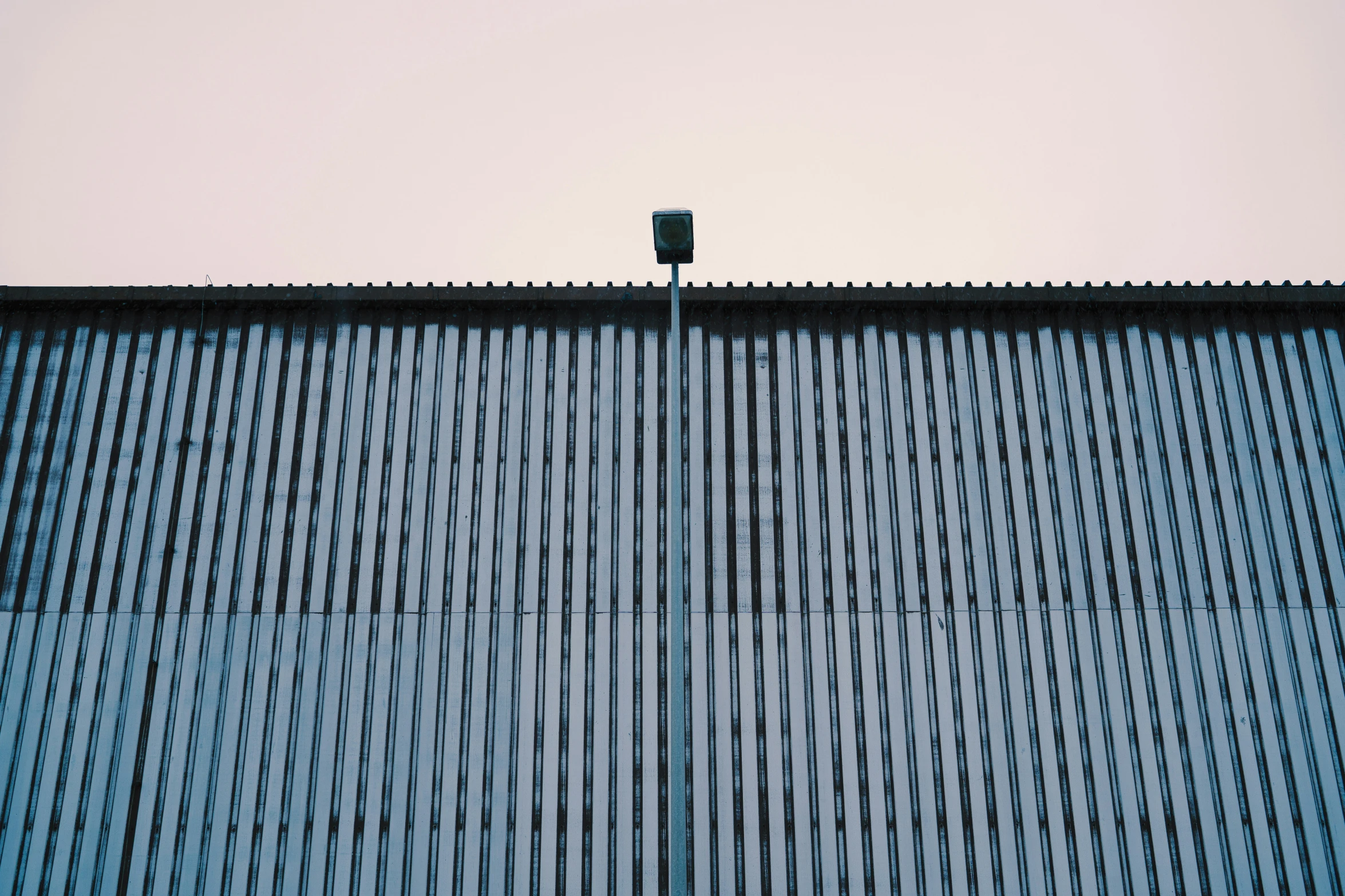 a lamp in the foreground of a modern building