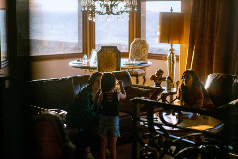 two girls are standing at the end of a couch