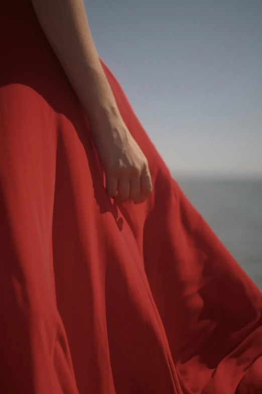 the foot of a person wearing a red dress