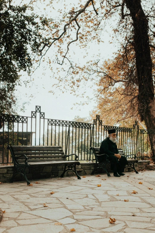 man sitting on a bench looking at his cellphone