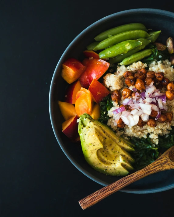 a bowl with grains, vegetables and chicken