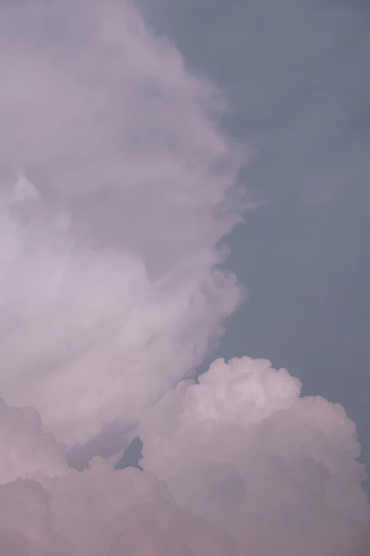 a bird sitting on the corner of a cloud