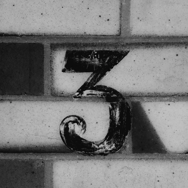 the letter s is placed on a brick wall