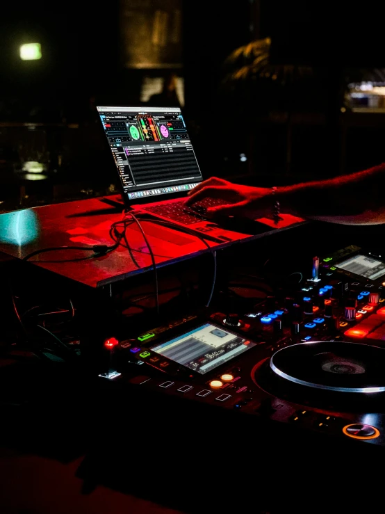 a dj works on his turntable at night