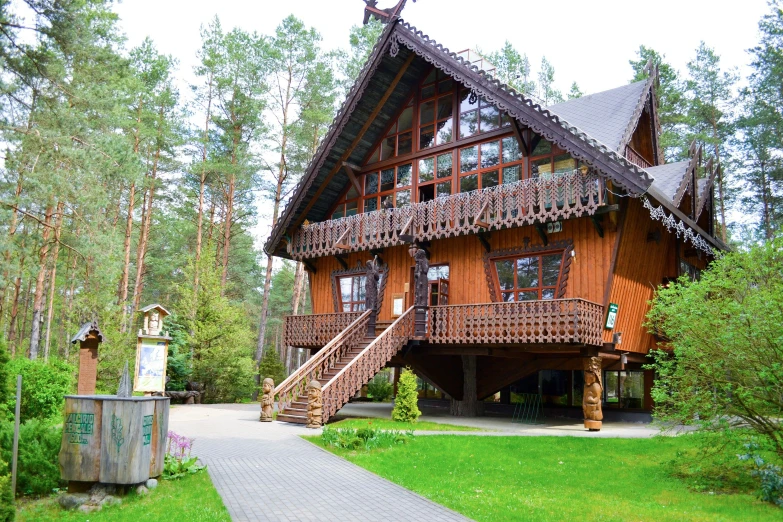 a large wooden house with wooden steps leading to it