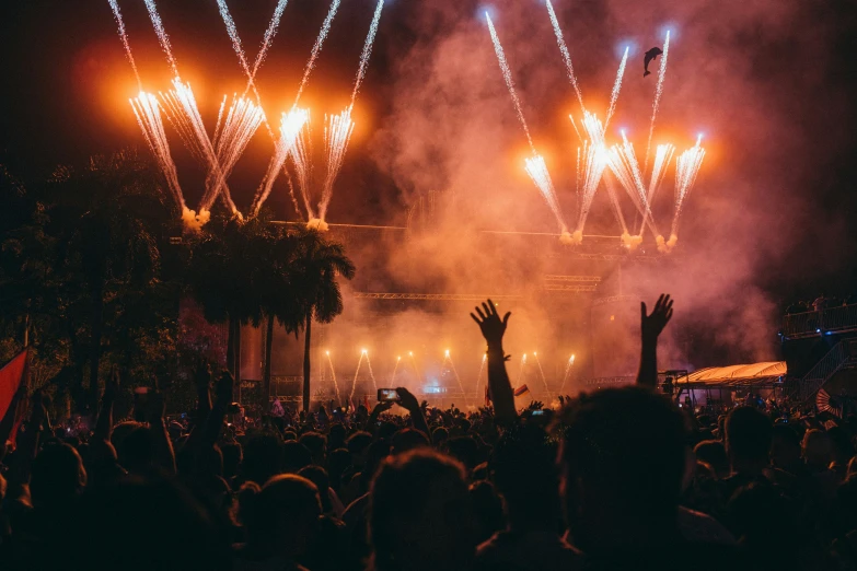 a large crowd watching a concert at night