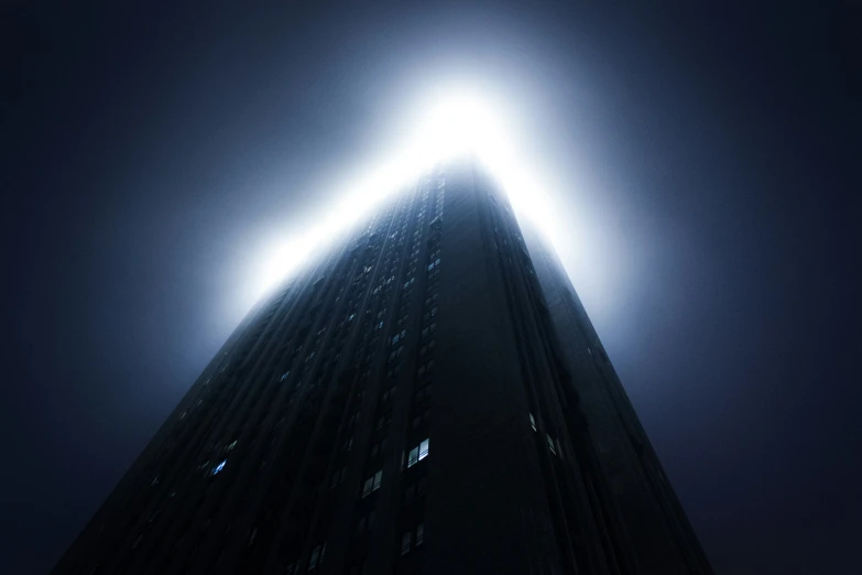 tall building with beams at night with the moon shining behind