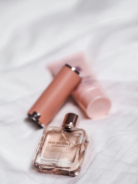 an assortment of cosmetics sits on a white surface