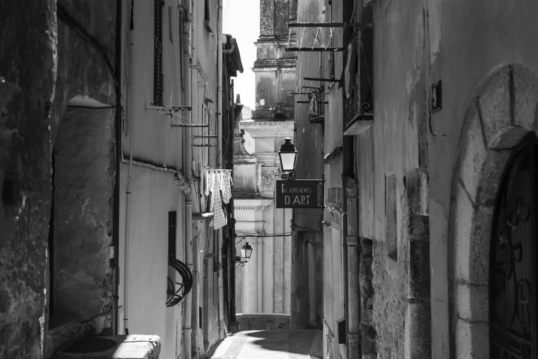 a narrow city street is lined with buildings