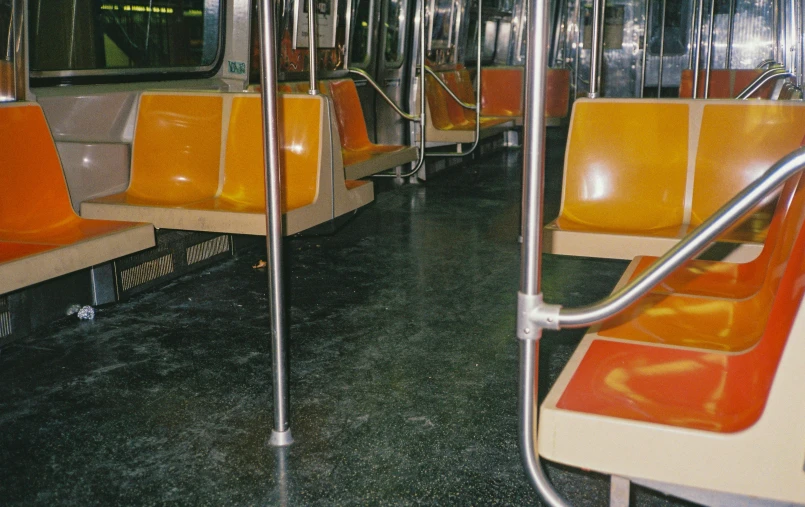 a public transit car with some metal handles