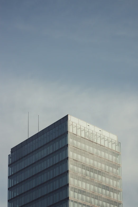 a tall skyscr with a very large building across the street