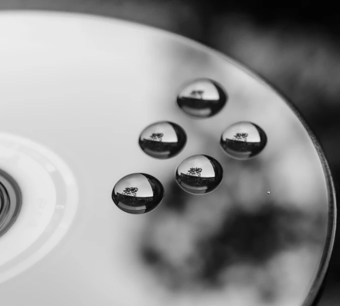 five discs with different pictures on them on a table