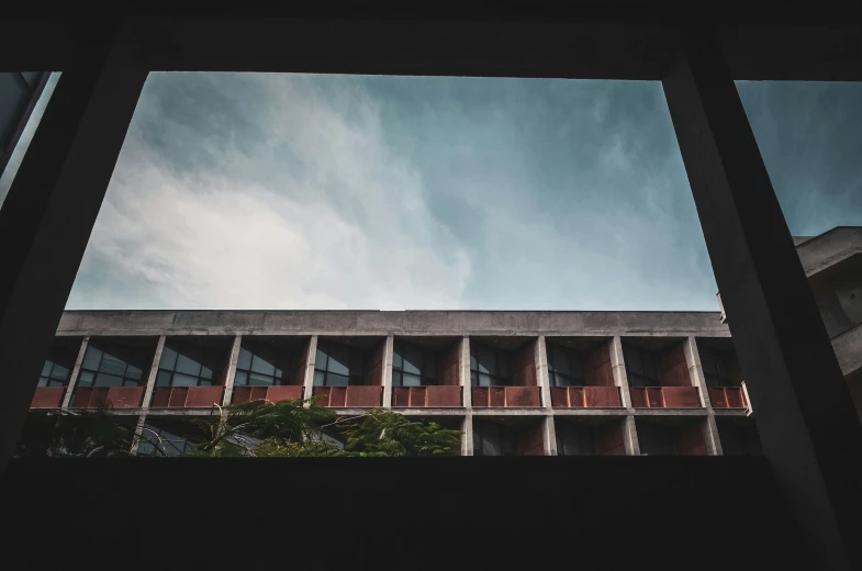 the view from inside of the building that has red balconies