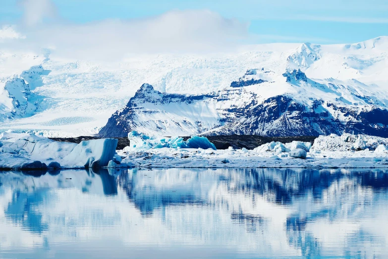 a beautiful view of a blue and white ice floating on the water