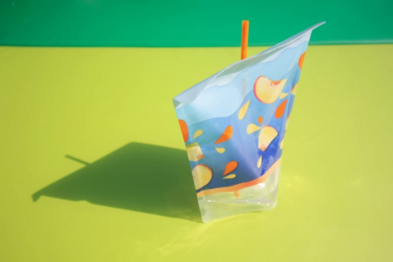 a blue and yellow treat bag on a green surface