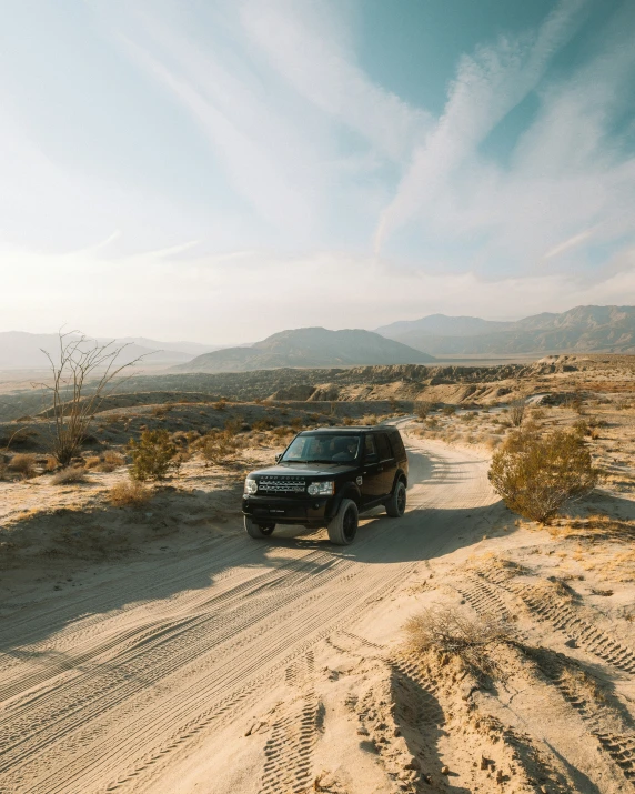 the truck is driving on the dirt road